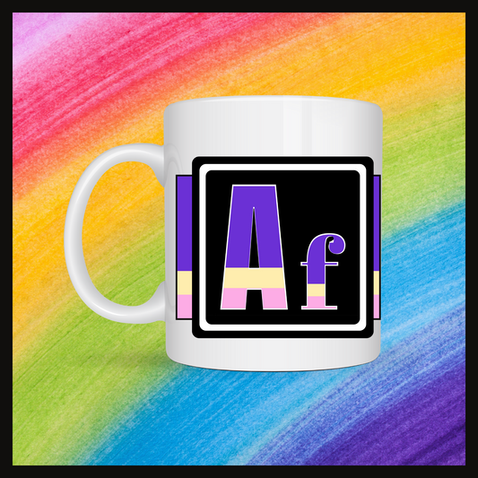White mug with a 3 inch square containing the element’s symbol (Af). Symbol is made with the colors of that element’s flag on a black background.  The pride flag is displayed behind the symbol. Behind the mug is a rainbow background.
