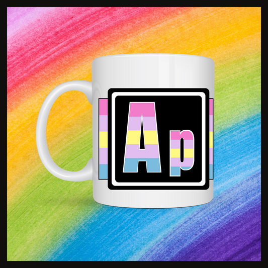 White mug with a 3 inch square containing the element’s symbol (Ap). Symbol is made with the colors of that element’s flag in a black square with the element’s flag behind the square. Behind the mug is a rainbow background.
