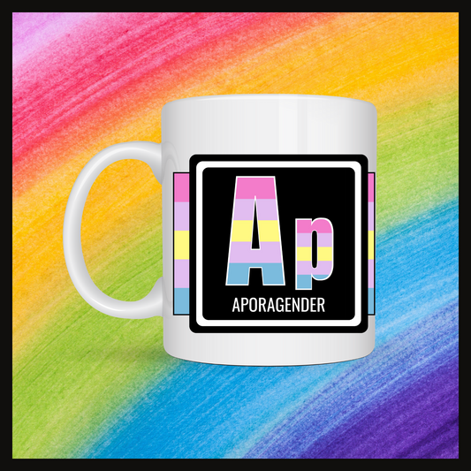 White mug with a 3 inch square containing the element’s symbol (Ap) and name (Aporagender). Symbol is made with the colors of that element’s flag in a black square with the element’s flag behind the square. Behind the mug is a rainbow background.