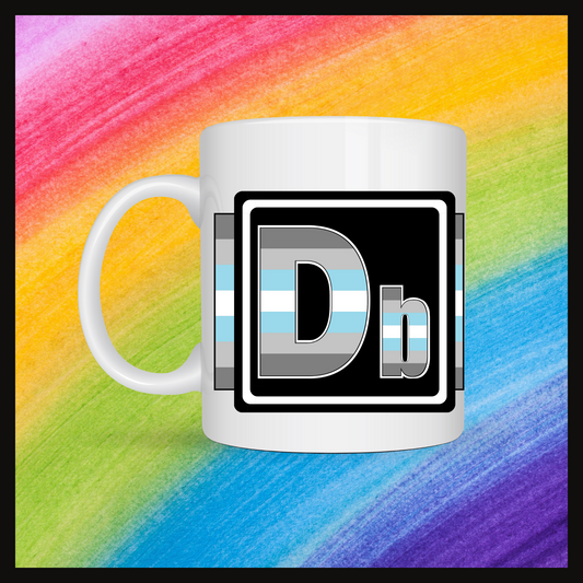White mug with a 3 inch square containing the element’s symbol (Db). Symbol is made with the colors of that element’s flag in a black square with the element’s flag behind the square. Behind the mug is a rainbow background.