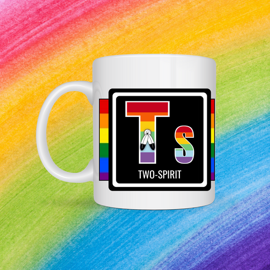 White mug with a 3 inch square containing the element’s symbol (Ts) and name (Two-Spirit). Symbol is made with the colors of that element’s flag in a black square with the element’s flag behind the square. Behind the mug is a rainbow background.