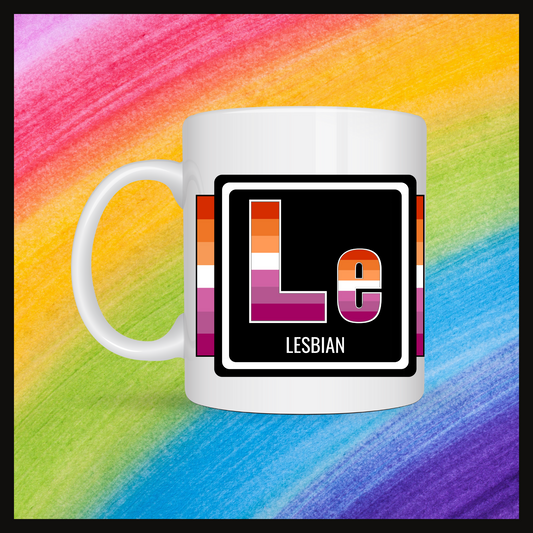 White mug with a 3 inch square containing the element’s symbol (Le) and name (Lesbian). Symbol is made with the colors of that element’s flag in a black square with the element’s flag behind the square. Behind the mug is a rainbow background.