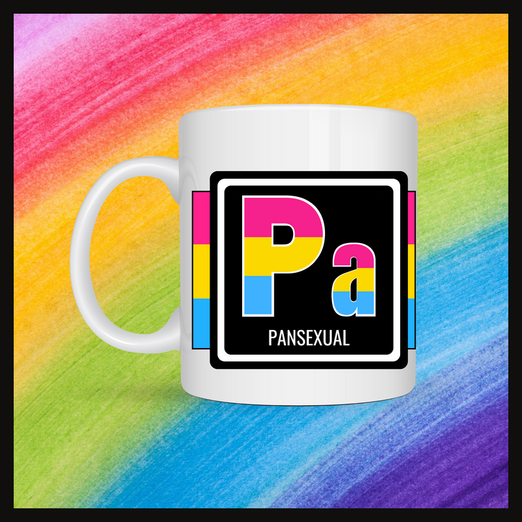White mug with a 3 inch square containing the element’s symbol (Pa) and name (Pansexual).Symbol is made with the colors of that element’s flag in a black square with the element’s flag behind the square. Behind the mug is a rainbow background.