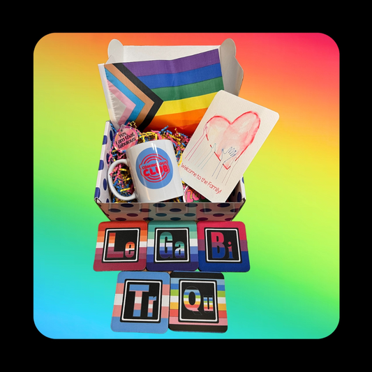 The EOP Coming Out Box welcomes your friends or loved ones to our community! Shown - the polka dot gift box which includes a cominc out club mug, a queer-themed keychain, a welcome to the family postcard and our lgbtq coasters