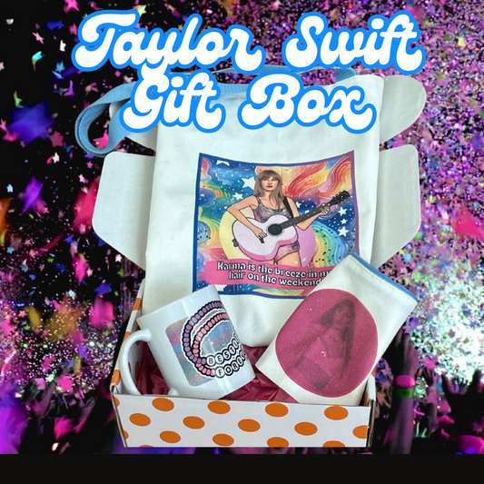 Shown is the Taylor Swift entire gift box. The background is a multicolored glitter photo. In the middle is the multi-color tote bag which says Karma is the breez in my hair..on the weekend. 
Below that to the left is a ceramic mug that shows two friendship bracelets that say besties forever. 
the last object is a makeup bag that has a pink design with taylor illustrated. 
