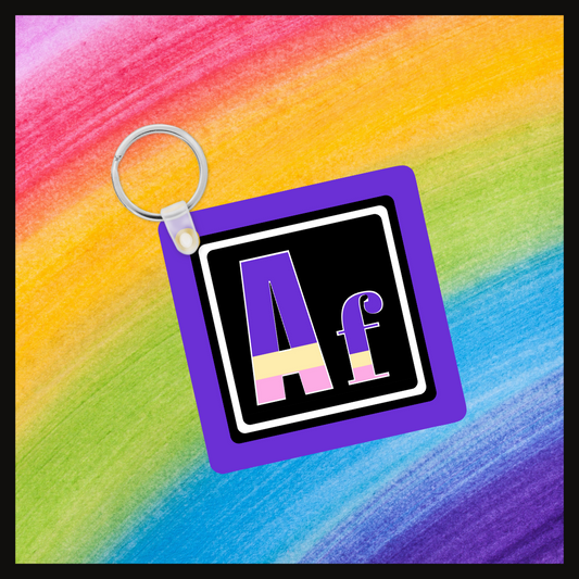 Keychain with the element symbol (Af) with a design based on the colors of that element’s flag in a black square with a purple background. Behind the keychain is a rainbow background.