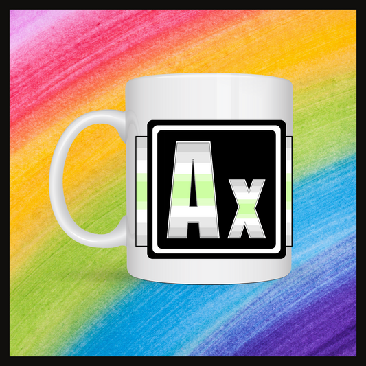 White mug with a 3 inch square containing the element’s symbol (Ax). Symbol is made with the colors of that element’s flag on a black background.The pride flag is displayed behind the symbol. Behind the mug is a rainbow background.