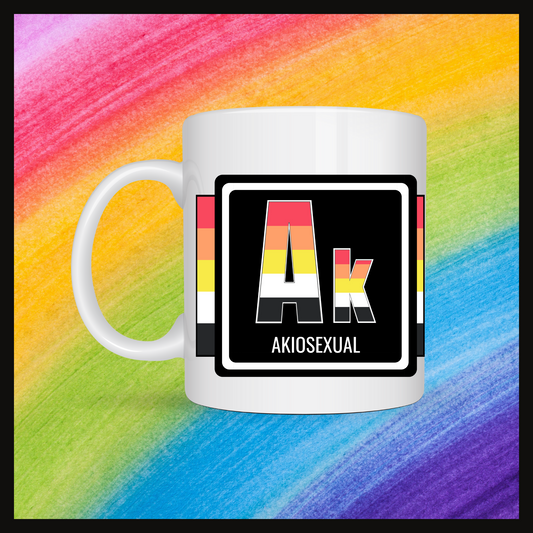 White mug with a 3 inch square containing the element’s symbol (Ak) and name (Akiosexual). Symbol is made with the colors of that element’s flag on a black background. The pride flag is displayed behind the symbol with a rainbow background.