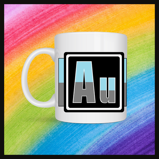 White mug with a 3 inch square containing the element’s symbol (Au). Symbol is made with the colors of that element’s flag in a black square with the element’s flag behind the square. Behind the mug is a rainbow background.