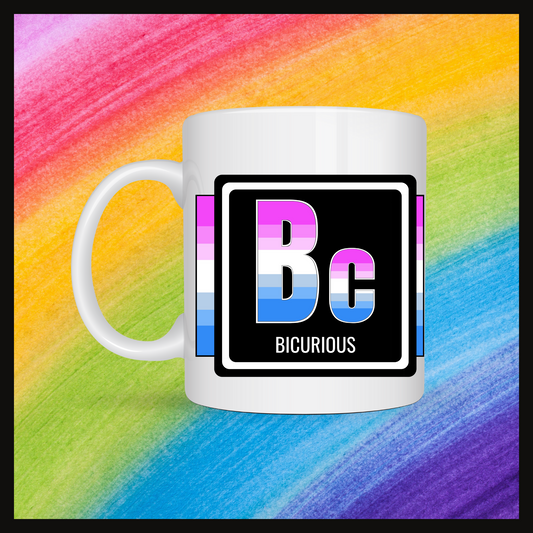 White mug with a 3 inch square containing the element’s symbol (Bc) and name (Bicurious). Symbol is made with the colors of that element’s flag on a black background. Behind the mug is a rainbow background.