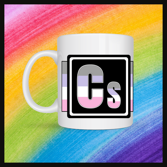 White mug with a 3 inch square containing the element’s symbol (Cs). Symbol is made with the colors of that element’s flag on a black background. Behind the mug is a rainbow background.