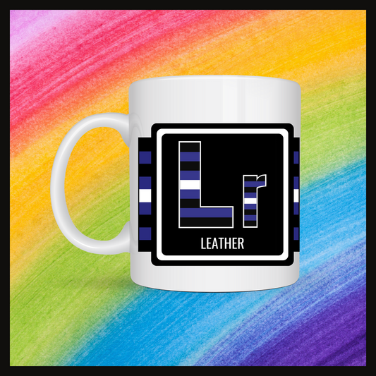 White mug with a 3 inch square containing the element’s symbol (Lr) and name (Leather). Symbol is made with the colors of that element’s flag in a black square with the element’s flag behind the square. Behind the mug is a rainbow background.