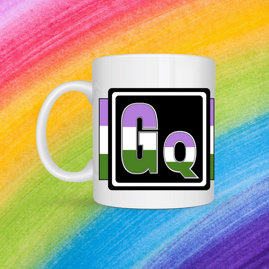 White mug with a 3 inch square containing the element’s symbol (Gq). ymbol is made with the colors of that element’s flag in a black square with the element’s flag behind the square. Behind the mug is a rainbow background.